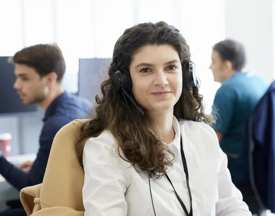 Health Partners employee with a headset on in the office, smiling