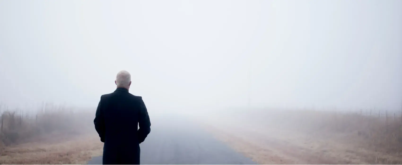 Man stood looking in to a fog