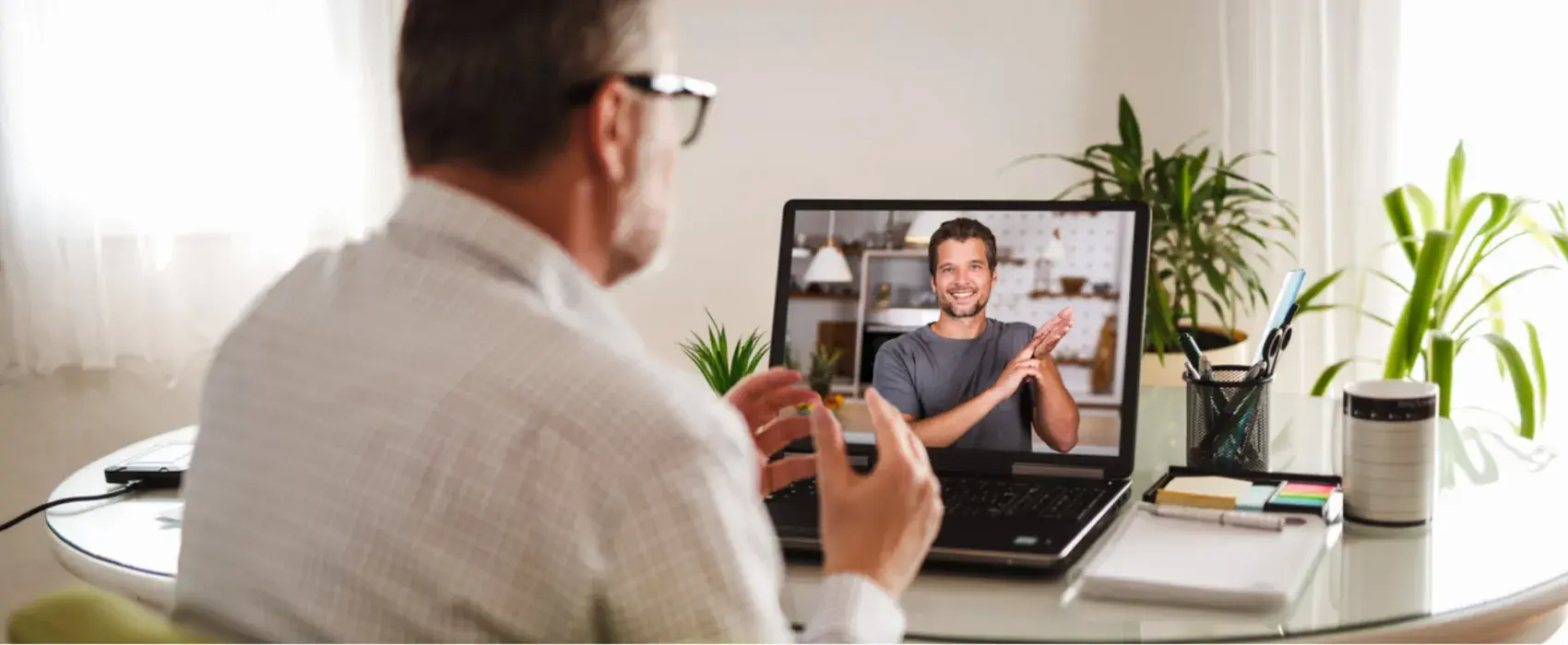 Man on video call doing sign language