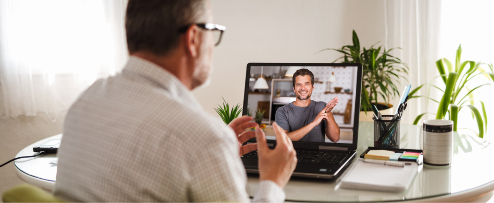 Man on video call doing sign language
