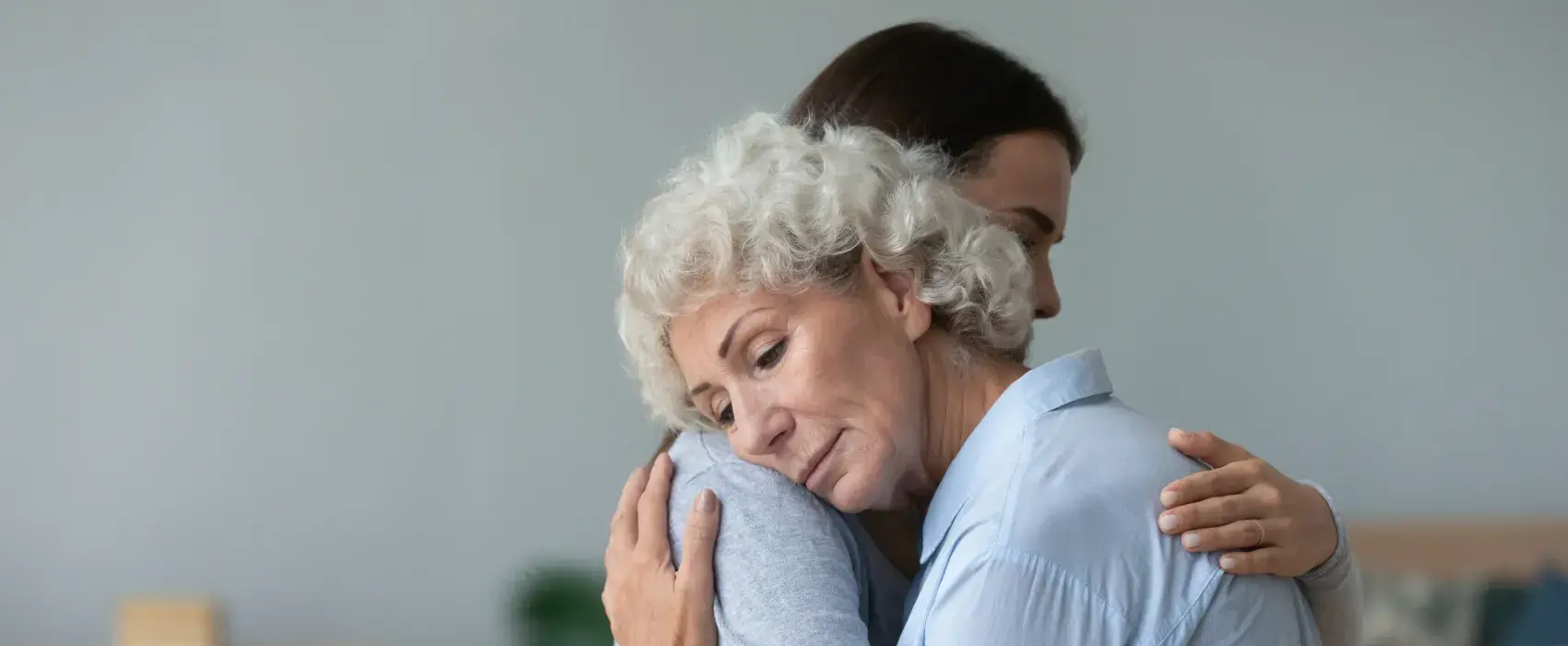 Lady hugging an older woman