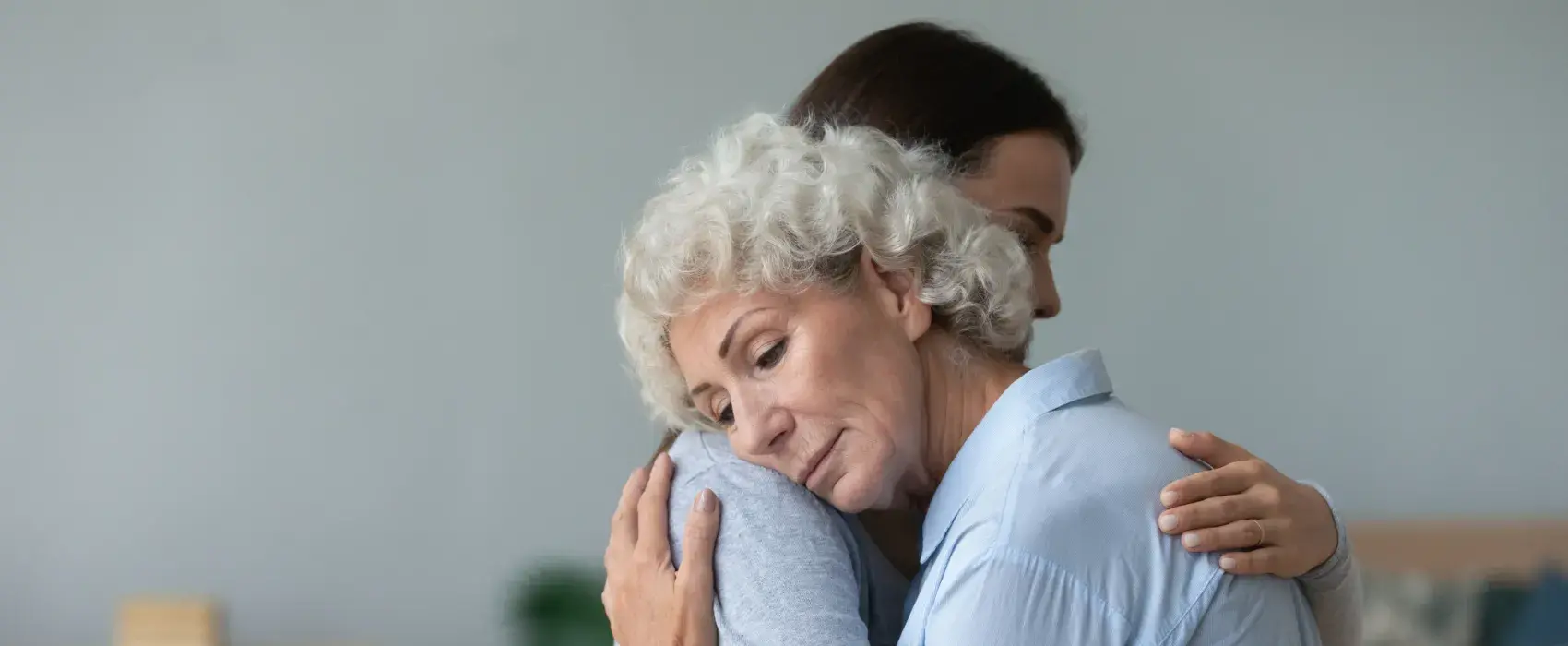 Lady hugging an older woman