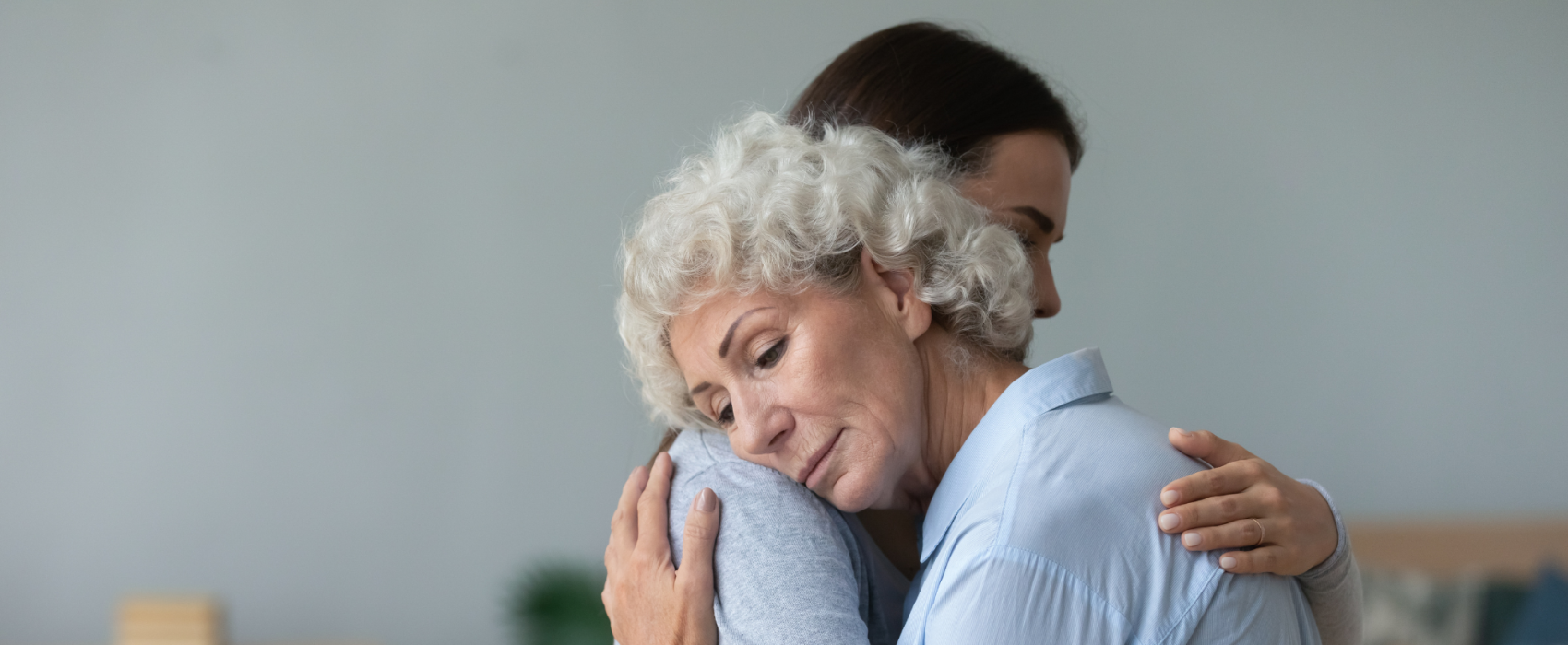 Lady hugging an older woman