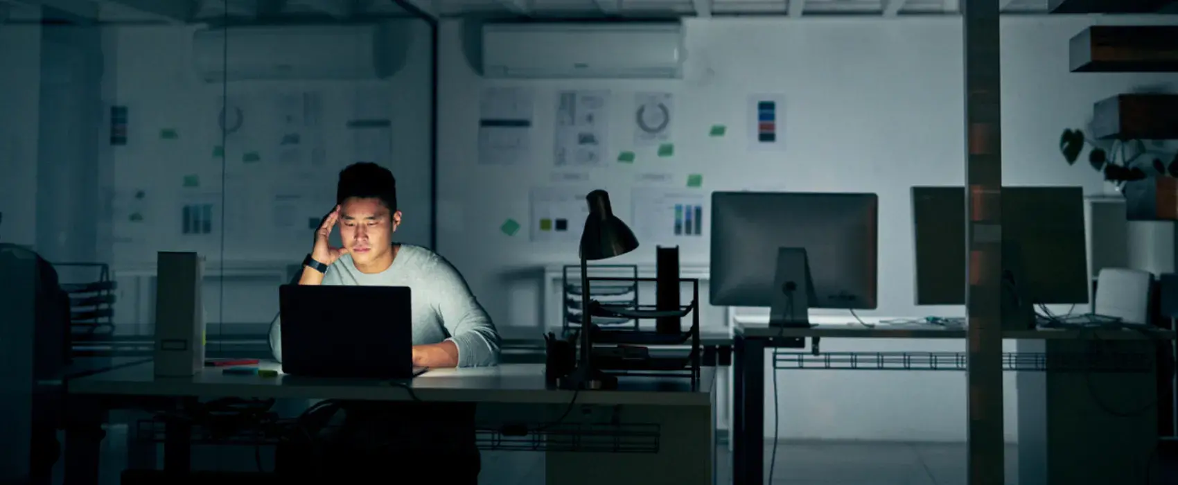 Man working alone in a dark office