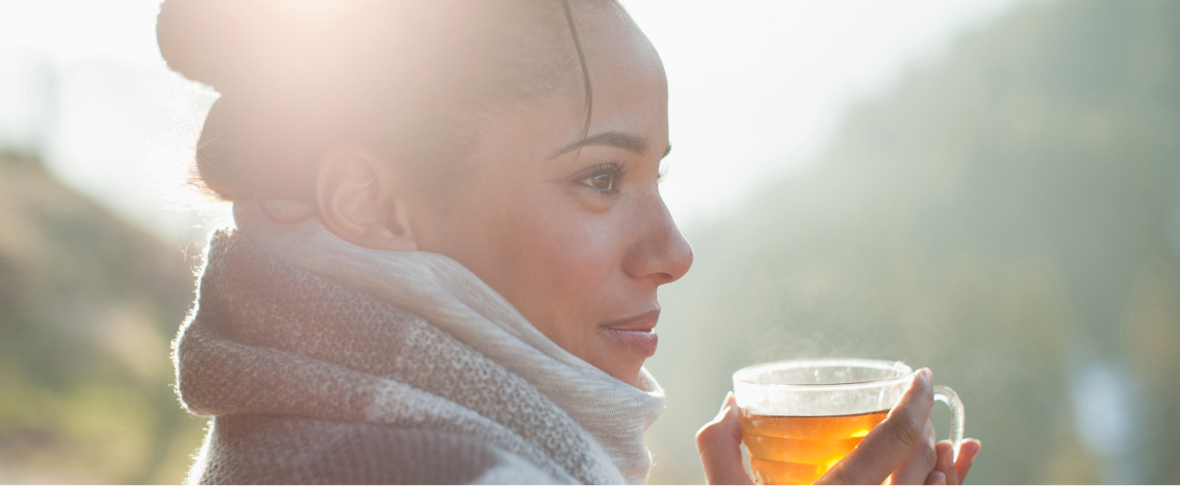 Woman drinking hot drink in the cold