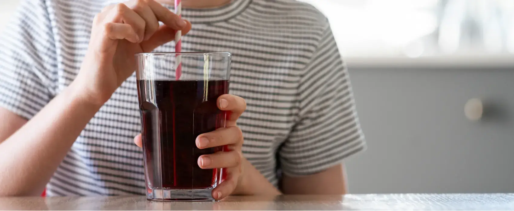 Drinking a glass of coke with a straw