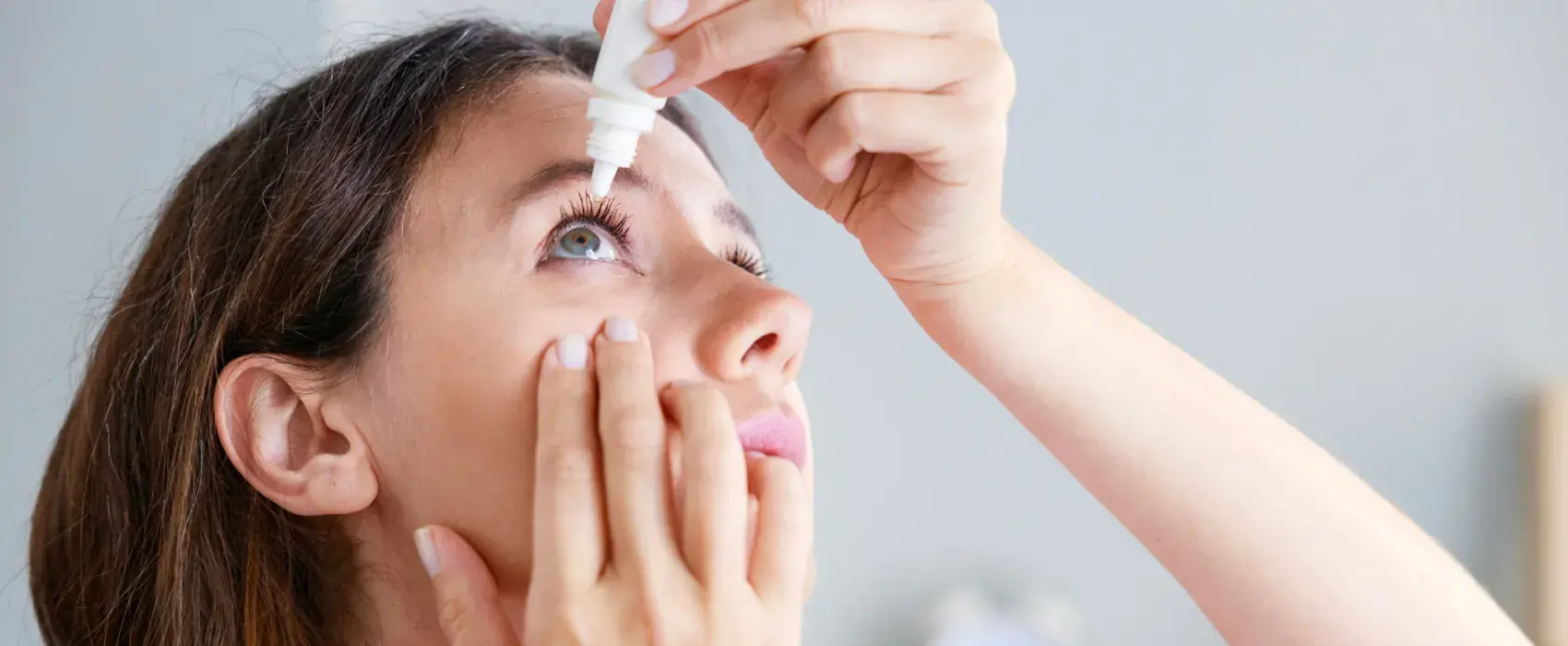 Women putting eye drops in
