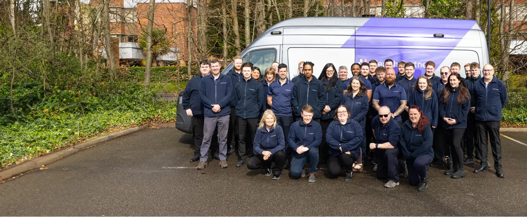Group of employees in front of a MMU van