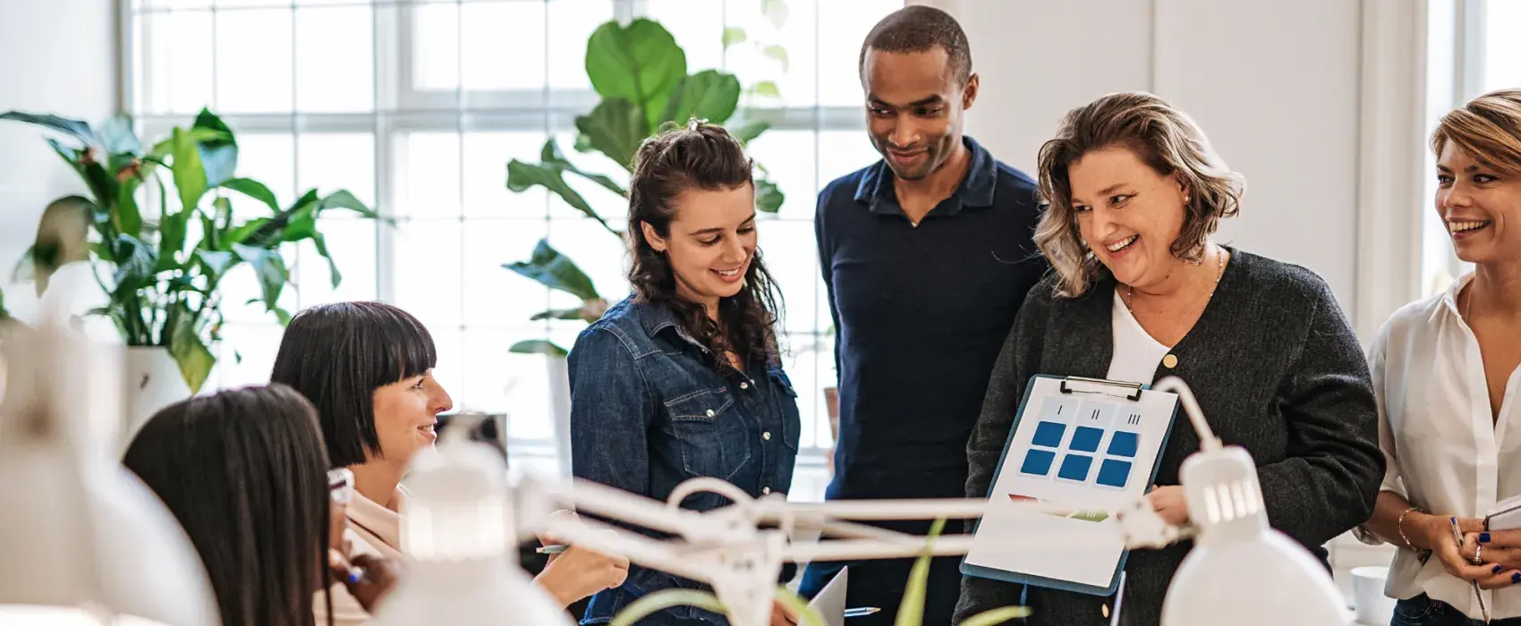 Group of people smiling in a workplace