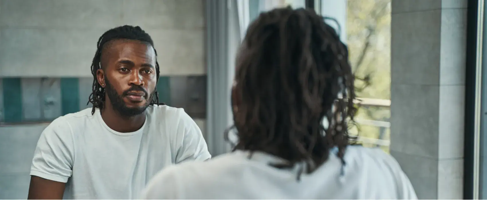 Man looking at himself in the mirror