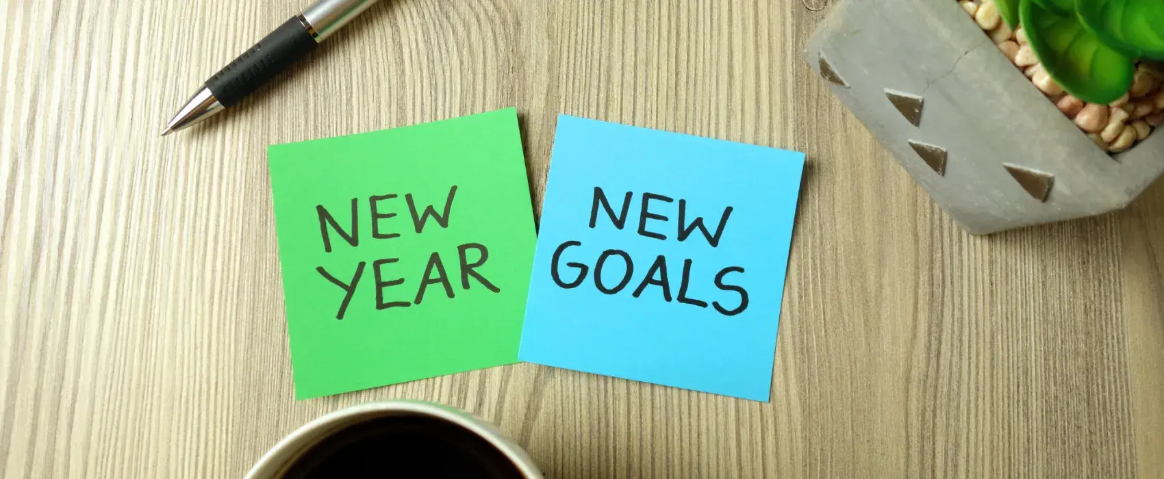 Sticky notes with new year, new goals written on
