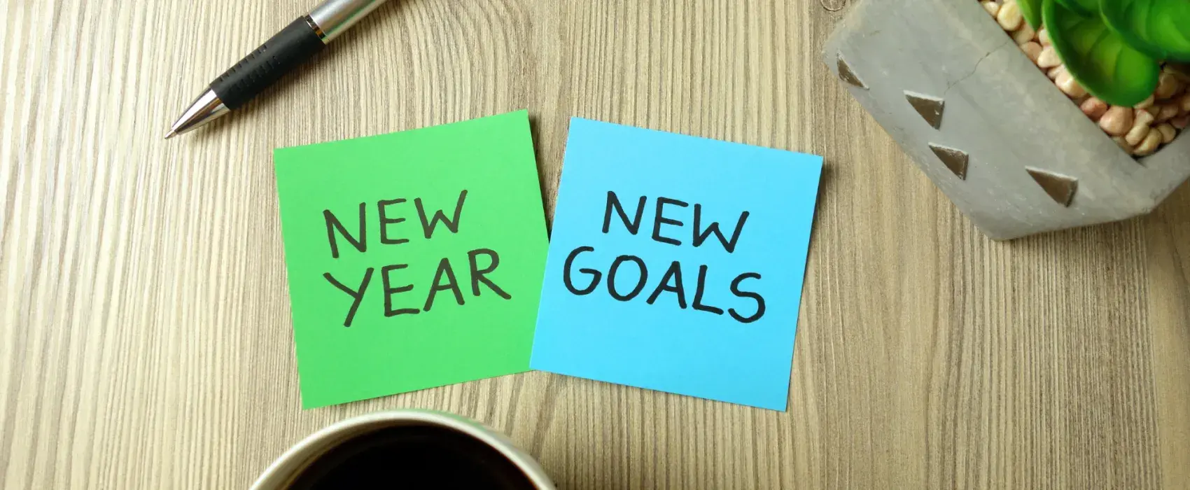 Sticky notes with new year, new goals written on