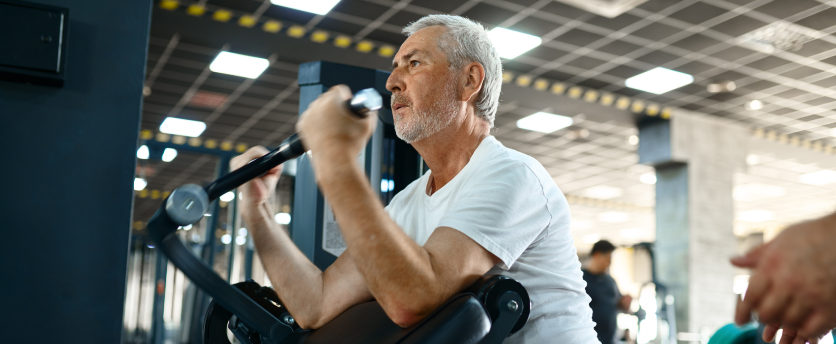 Older man on a weight machine at the gym