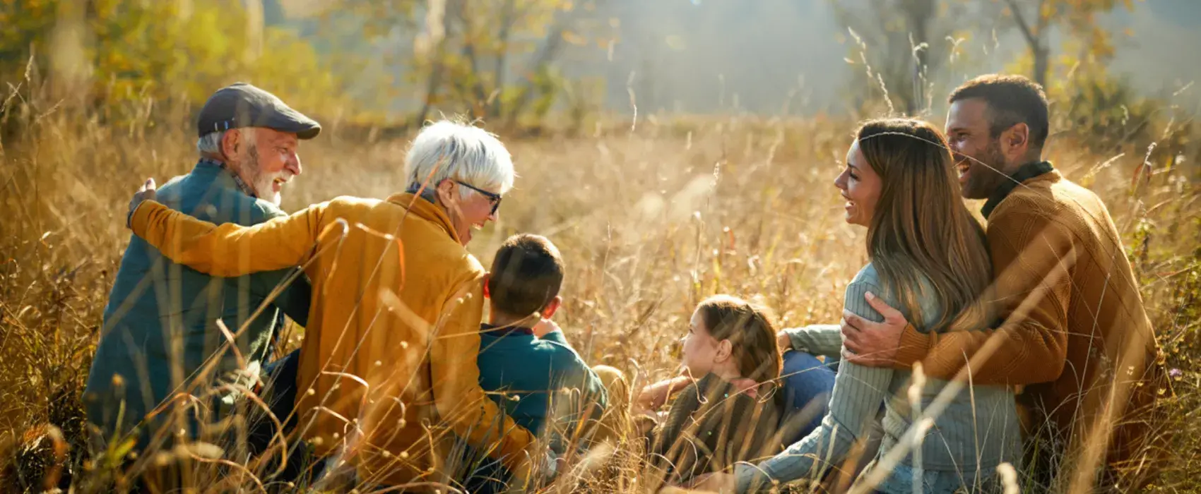 family sitting in the grass