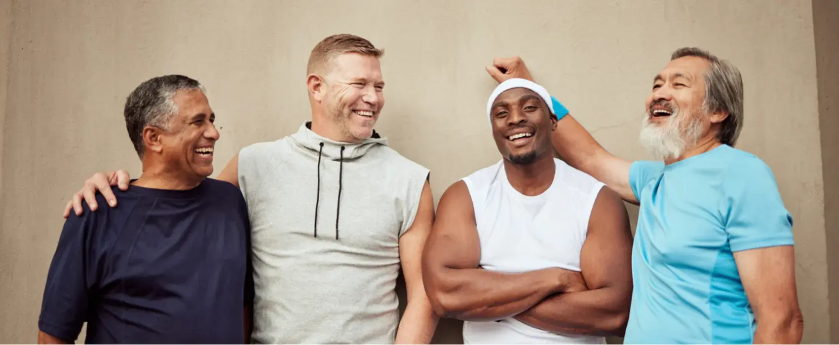 4 mixed race men in athletic clothing