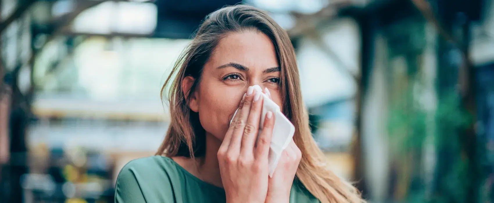Woman sneezing in work