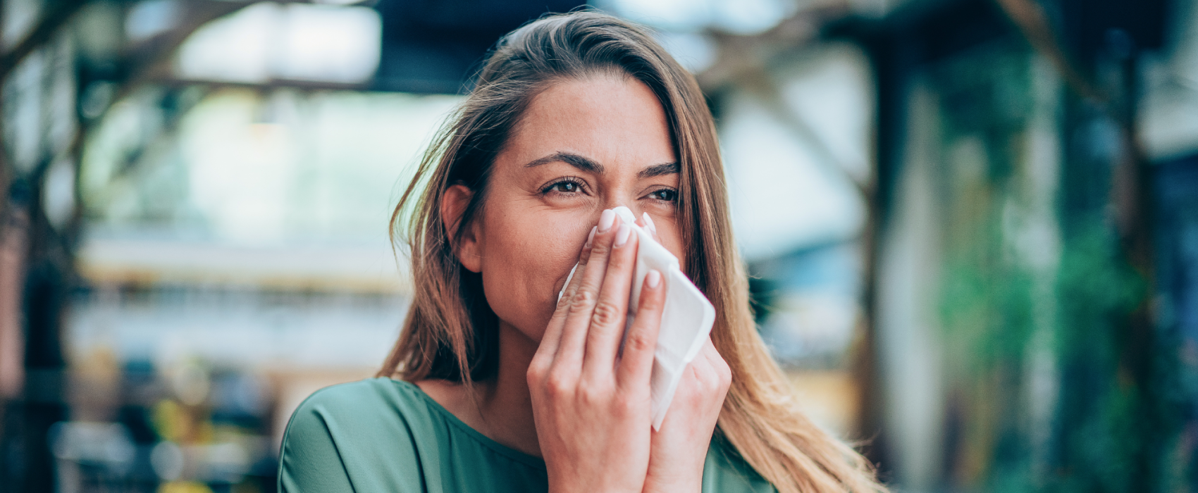 Woman sneezing in work
