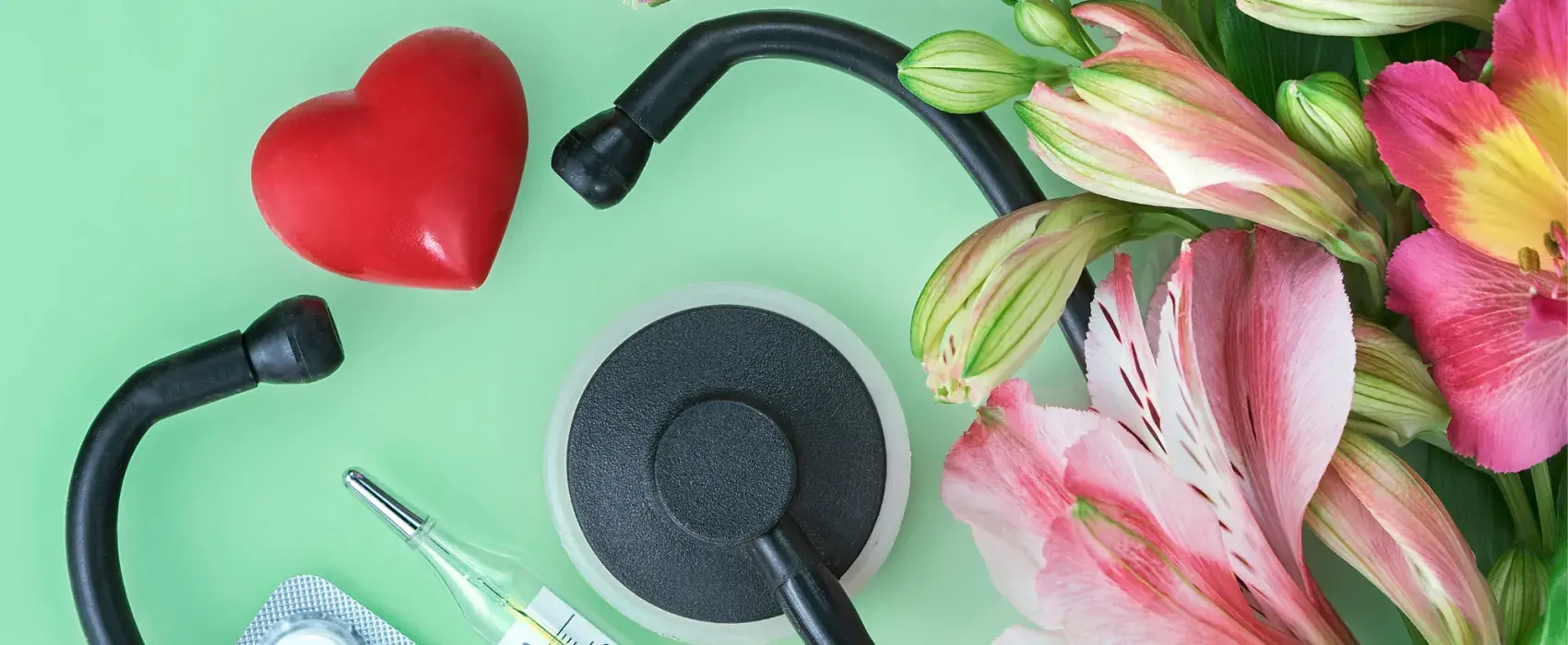 Flatlay of nurse instruments and flowers