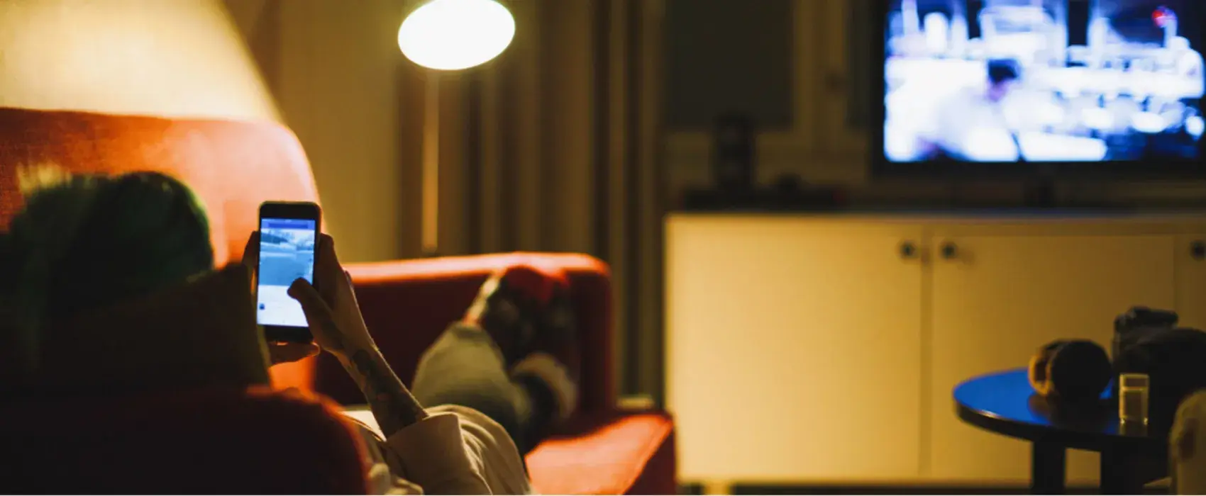 Women on phone watching tv