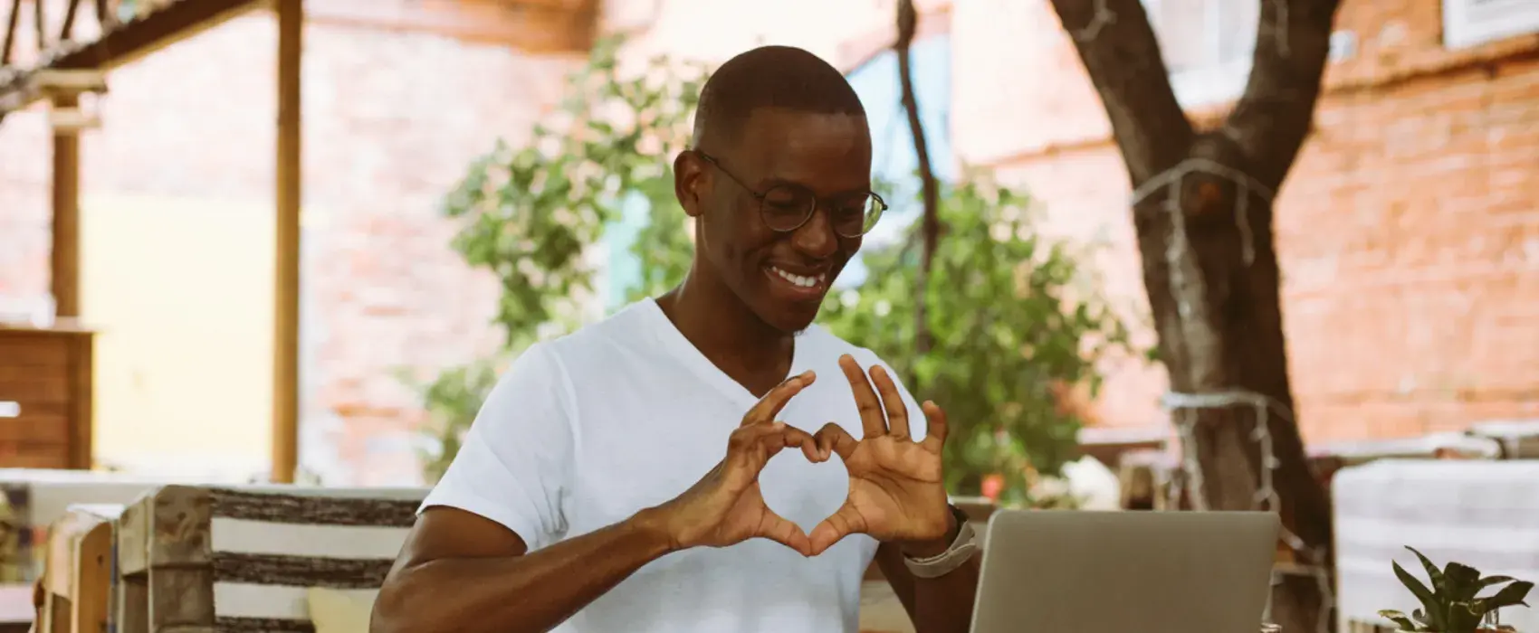 Man making a love heart with his hands