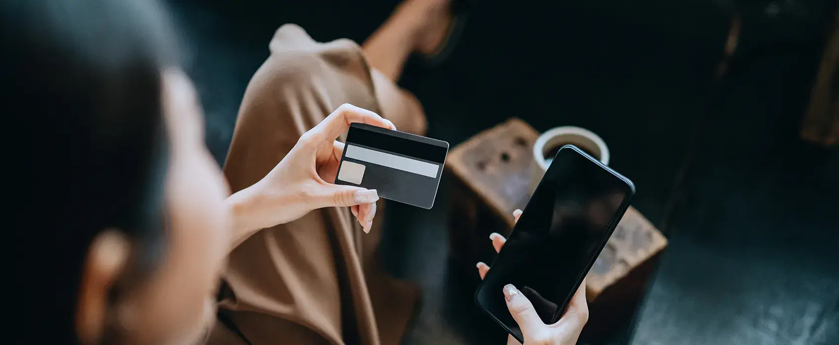 Women paying with card on phone