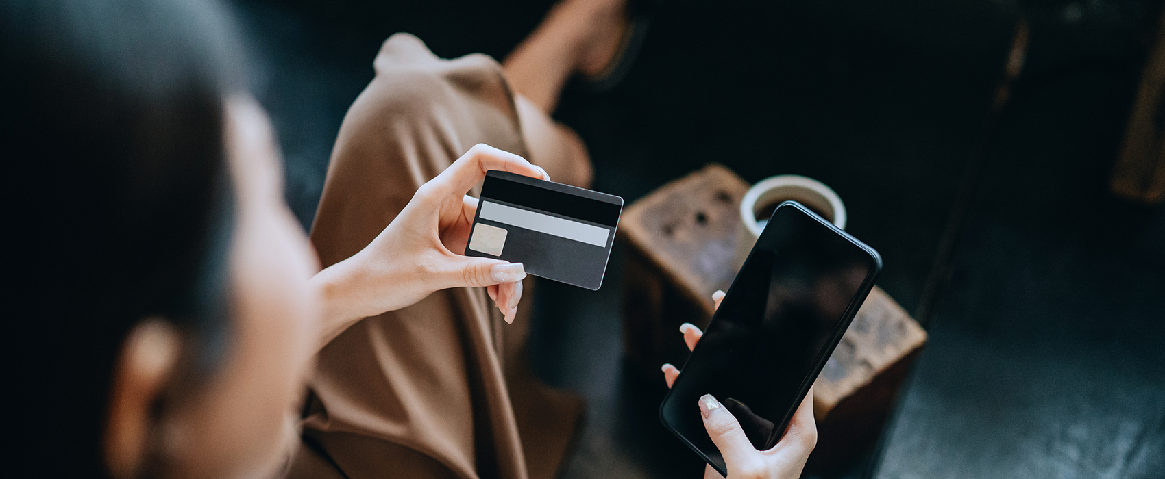 Women paying with card on phone