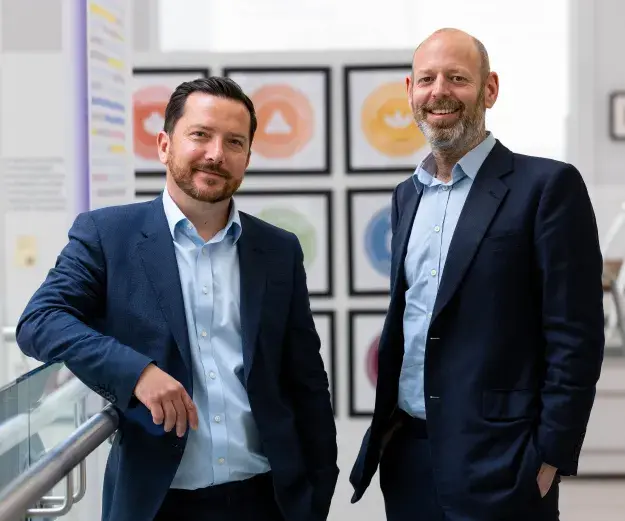 Dr Joe Buckman standing next to Dr Ben Barnaby in a well-lit corridor