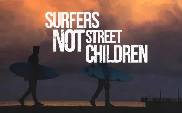 2 men holding surfboards .... , text on the image reads "surfers not street children"