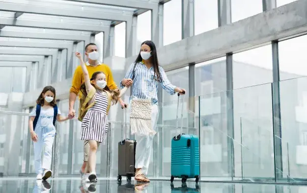 Family in an airport with masks on